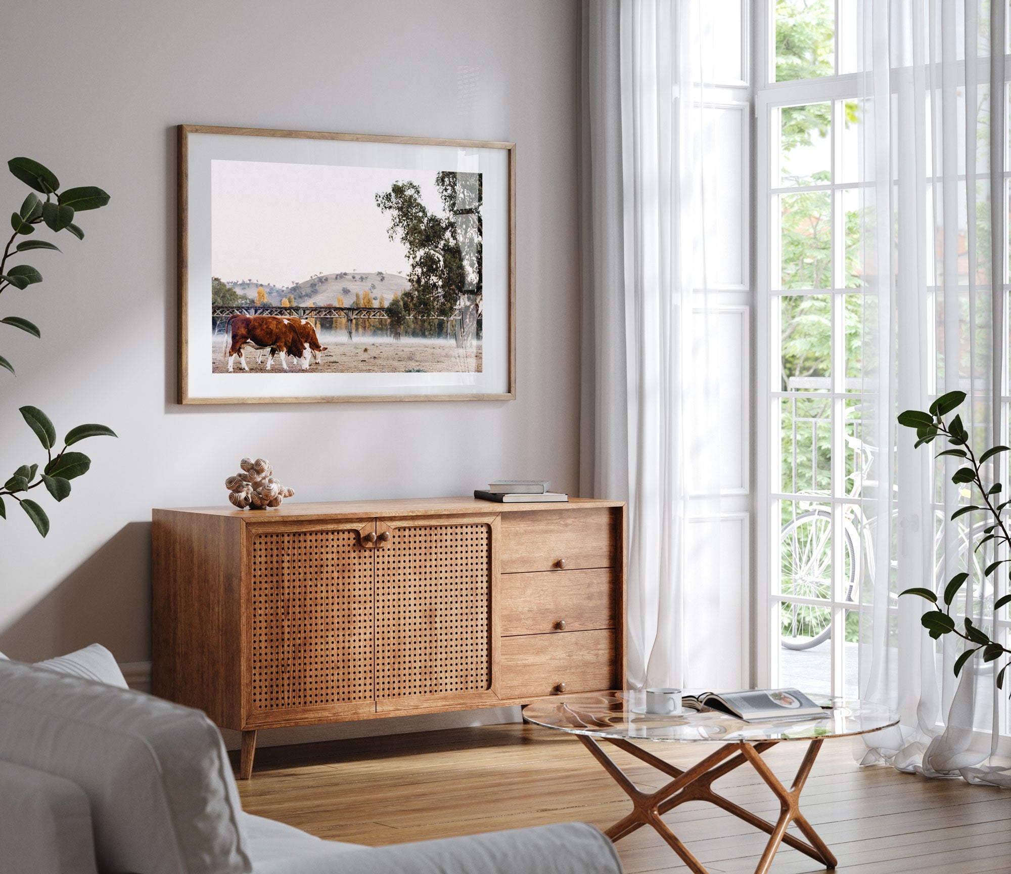 Emily O'Brien Gundagai Cows by the Bridge photographic print featuring cows near the river landscape on a timber console.